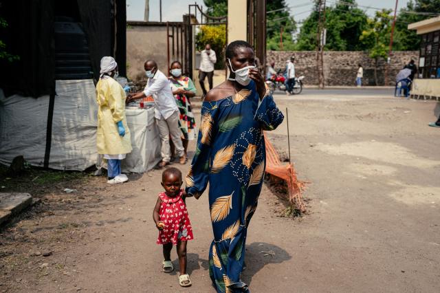 A woman wearing a mask as a preventive measure enters Kyeshero Hospital after passing a checkpoint for hand washing and health screening in Goma on May 18, 2026. A first case of Ebola virus infection has been reported in Goma, a major city in eastern Democratic Republic of Congo controlled by the M23 armed group, with the WHO declaring an international health alert on May 17, 2026. (Photo by Jospin Mwisha / AFP)