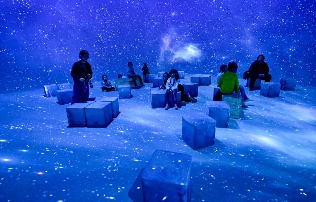 Children of a school class visit the multimedia exhibition "polar experience" during a media preview at OBEX Oberhausen in Oberhausen, western Germany, on May 18, 2026. The immersive exhibition “POLAR EXPERIENCE” takes visitors on a breathtaking journey into the fascinating world of the Arctic and Antarctic and runs from 19 May to 31 November 2026. (Photo by Ina FASSBENDER / AFP)