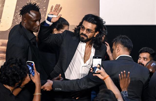 Indian actor Ram Charan (C) attends the trailer launch of his upcoming film 'Peddi' in Mumbai on May 18, 2026. (Photo by Sujit JAISWAL / AFP)