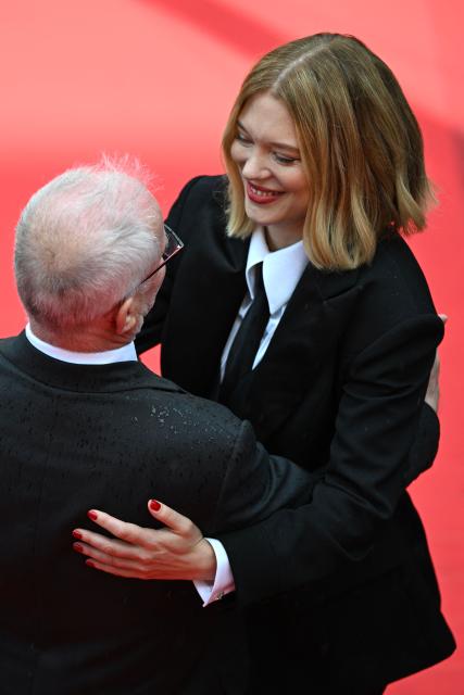 Cannes film festival director Thierry Fremaux hugs French actress Lea Seydoux arrive for the screening of the film "L'Inconnue" (The Unknown) at the 79th edition of the Cannes Film Festival in Cannes, southern France on May 18, 2026. (Photo by Antonin THUILLIER / AFP)