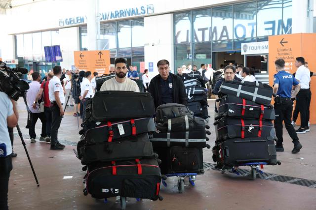 Members of the Iranian national football team exit a terminal following their arrival in Turkey ahead of their trip to the United States for the FIFA World Cup 2026, at Antalya airport in Antalya, southern Turkey, on May 18, 2026. Iran's football team arrived in Turkey on Monday for a training camp and to complete visa applications ahead of the 2026 World Cup, AFP correspondents said. (Photo by Oner SAN / AFP)