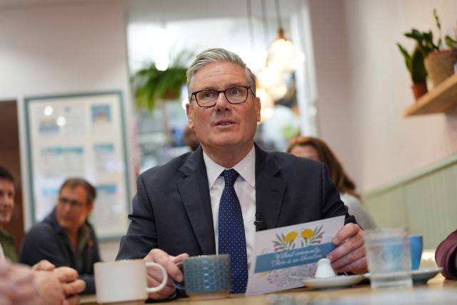 Britain's Prime Minister Keir Starmer reacts as he speaks to small business owners, during a visit to Home Cafe and Kitchen in Kensal Rise, north west London, on May 18, 2026. (Photo by Yui Mok / POOL / AFP)