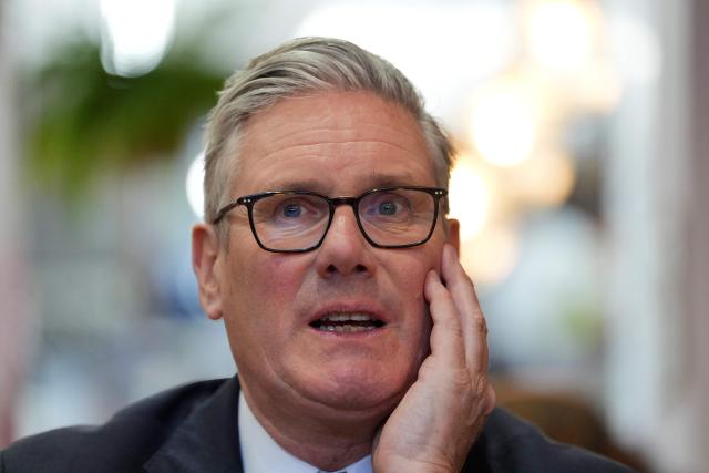 Britain's Prime Minister Keir Starmer reacts as he speaks to small business owners, during a visit to Home Cafe and Kitchen in Kensal Rise, north west London, on May 18, 2026. (Photo by Yui Mok / POOL / AFP)