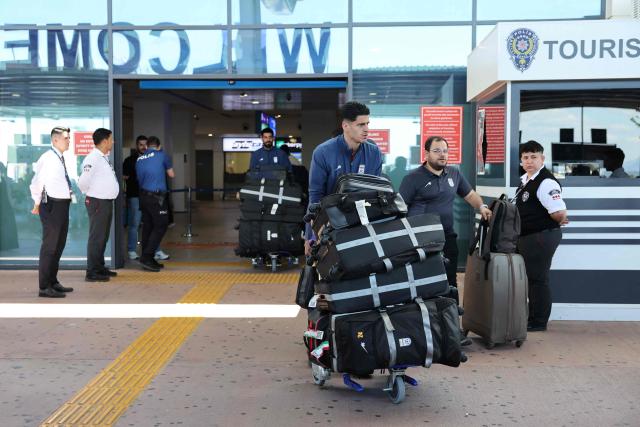 Members of the Iranian national football team exit a terminal following their arrival in Turkey ahead of their trip to the United States for the FIFA World Cup 2026, at Antalya airport in Antalya, southern Turkey, on May 18, 2026. Iran's football team arrived in Turkey on Monday for a training camp and to complete visa applications ahead of the 2026 World Cup, AFP correspondents said. (Photo by Oner SAN / AFP)