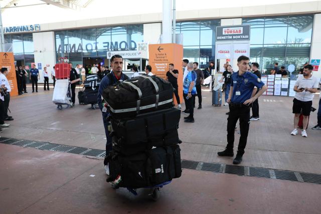 Members of the Iranian national football team exit a terminal following their arrival in Turkey ahead of their trip to the United States for the FIFA World Cup 2026, at Antalya airport in Antalya, southern Turkey, on May 18, 2026. Iran's football team arrived in Turkey on Monday for a training camp and to complete visa applications ahead of the 2026 World Cup, AFP correspondents said. (Photo by Oner SAN / AFP)