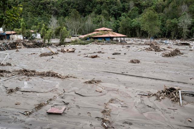 (FILES) Mud and debris cover the recreational and tourist centre Valle Hermoso in Cacute, Merida State, western Venezuela, on June 25, 2025, after heavy rains caused the flooding of the Chama river. Heat waves and other extreme weather ravaged Latin America and the Caribbean in 2025, but tallying the death toll from these events is a near-impossible task, a report published by the World Meteorological Organization (WMO) in Brasilia on May 18, 2026, warned. (Photo by Miguel ZAMBRANO / AFP)
