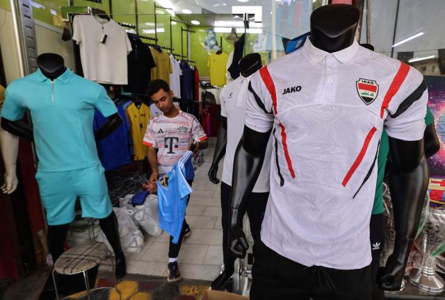 A football jersey bearing the Iraqi national flag is displayed at a sportswear shop in Baghdad on May 18, 2026, ahead of the 2026 FIFA World Cup, for which the country qualified. The "Lions of Mesopotamia" secured the country's first World Cup appearance since the 1986 competition in Mexico with a 2-1 win over Bolivia on March 31, 2026. (Photo by AHMAD AL-RUBAYE / AFP)
