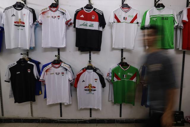 Football jerseys bearing the Iraqi national flag are displayed at a sportswear shop in Baghdad on May 18, 2026, ahead of the 2026 FIFA World Cup, for which the country qualified. The "Lions of Mesopotamia" secured the country's first World Cup appearance since the 1986 competition in Mexico with a 2-1 win over Bolivia on March 31, 2026. (Photo by AHMAD AL-RUBAYE / AFP)