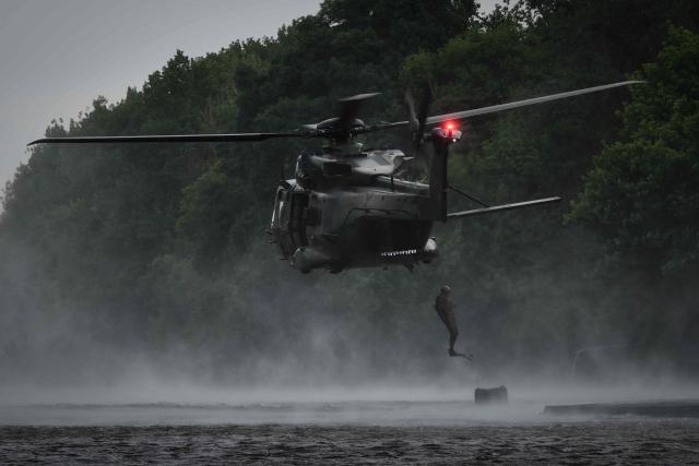 A French Foreign Legion combat diver from the 2nd Foreign Parachute Regiment (2e REP) leaps from a NH90 Caïman helicopter into the River Vienne during an airborne water insertion exercise in Ingrandes, south-western France, on May 18, 2026. The LIBECCIU 2026 military exercise, running from May 11 to May 20, 2026 across Nouvelle-Aquitaine and Centre-Val de Loire regions, tests short-notice redeployment and interoperability between air and ground components  capabilities central to France's contribution to NATO rapid-reaction forces. (Photo by Philippe LOPEZ / AFP)