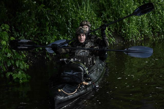 French Foreign Legion combat divers from the 2nd Foreign Parachute Regiment (2e REP) paddle an inflatable boat along the bank of the River Vienne during a water infiltration exercise in Ingrandes, south-western France, on May 18, 2026. The LIBECCIU 2026 military exercise, running from May 11 to May 20, 2026 across Nouvelle-Aquitaine and Centre-Val de Loire regions, tests short-notice redeployment and interoperability between air and ground components  capabilities central to France's contribution to NATO rapid-reaction forces. (Photo by Philippe LOPEZ / AFP)