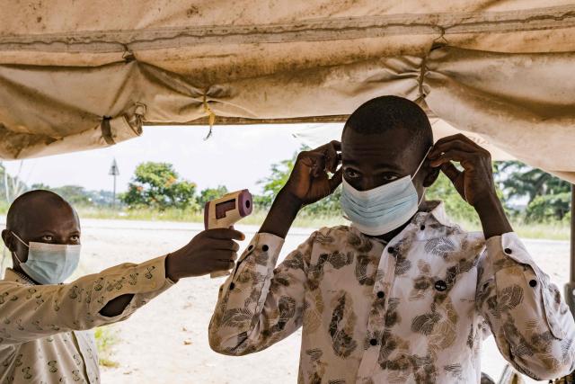 TOPSHOT - A border health officer at the Busunga crossing between Uganda and the Democratic Republic of Congo checks a travelers temperature using a contactless infrared thermometer in Bundibugyo, on May 18, 2026. Ugandan officials confirmed that a 59-year-old man from Democratic Republic of Congo had died in Kampala after being admitted earlier in the week. Tests showed the victim in Uganda was infected with the Bundibugyo strain of Ebola, first identified in 2007.
The World Health Organization declared an international health emergency on May 17, 2026 over an outbreak of an Ebola strain in the Democratic Republic of Congo that has killed more than 80 and for which there is no vaccine. Fears of further spread grew when a laboratory confirmed a case in the major eastern DRC city of Goma, which is controlled by the Rwanda-backed M23 militia. (Photo by Badru Katumba / AFP)
