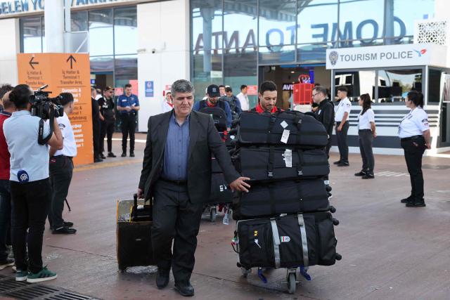 Members of the Iranian national football team exit a terminal following their arrival in Turkey ahead of their trip to the United States for the FIFA World Cup 2026, at Antalya airport in Antalya, southern Turkey, on May 18, 2026. Iran's football team arrived in Turkey on Monday for a training camp and to complete visa applications ahead of the 2026 World Cup, AFP correspondents said. (Photo by Oner SAN / AFP)