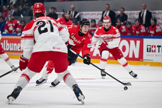 Canada’s forward #71 Macklin Celebrini controls the puck during the groupe B match between Canada and Denmark at the IIHF Ice Hockey Men's World Championship at BFC Arena, in Fribourg, Switzerland, on May 18, 2026. (Photo by Fabrice COFFRINI / AFP)