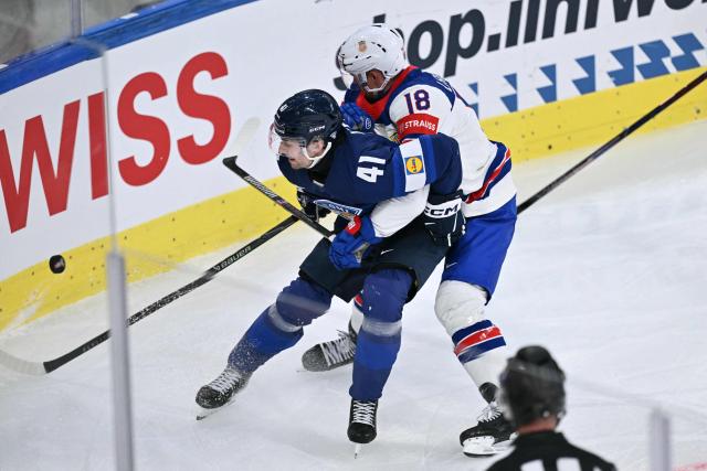 Finland's defender #41 Ville Heinola (L) fights for the puck with USA's forward #18 Sam Lafferty  during the IIHF Ice Hockey Men's World Championship first round group A match between Finland and USA at the Swiss Life Arena in Zurich on May 18, 2026. (Photo by SEBASTIEN BOZON / AFP)