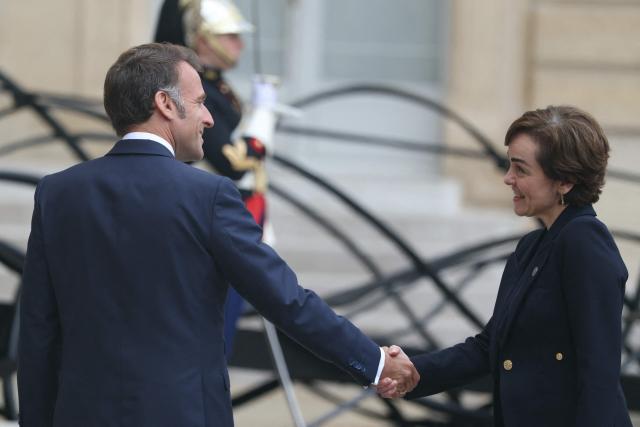 France's President Emmanuel Macron (L) shakes hands with the Premier of Quebec Christine Frechette as she arrives prior to their meeting at the Elysee Presidential Palace in Paris on May 18, 2026. (Photo by Alain JOCARD / AFP)