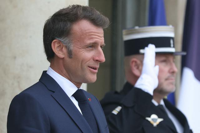 France's President Emmanuel Macron (L) reacts as he awaits the Premier of Quebec prior to their meeting at the Elysee Presidential Palace in Paris on May 18, 2026. (Photo by Alain JOCARD / AFP)