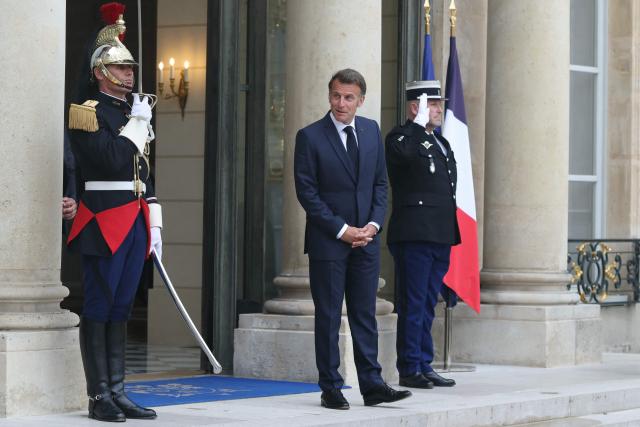 France's President Emmanuel Macron (C) reacts as he awaits the Premier of Quebec prior to their meeting at the Elysee Presidential Palace in Paris on May 18, 2026. (Photo by Alain JOCARD / AFP)