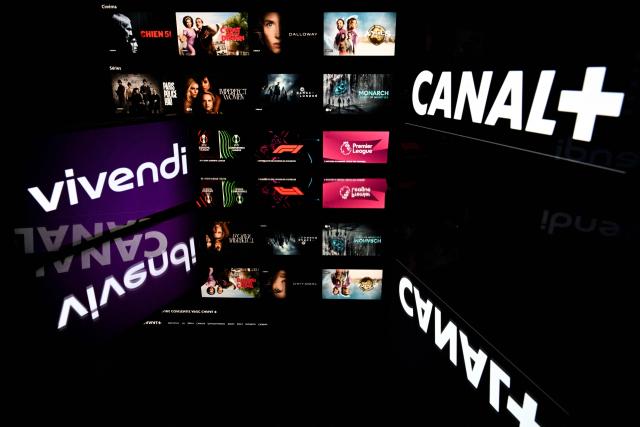 This illustration photograph shows screens displaying the logos of the French private television channel Canal Plus (Canal+) and French media group Vivendi with the backdrop of its online streaming platform "MyCanal" in Toulouse, south-western France, on May 18, 2026. (Photo by Lionel BONAVENTURE / AFP)