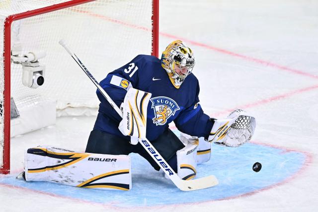 Finland's goalkeeper #31 Justus Annunen dives for the puck  during the IIHF Ice Hockey Men's World Championship first round group A match between Finland and USA at the Swiss Life Arena in Zurich on May 18, 2026. (Photo by SEBASTIEN BOZON / AFP)
