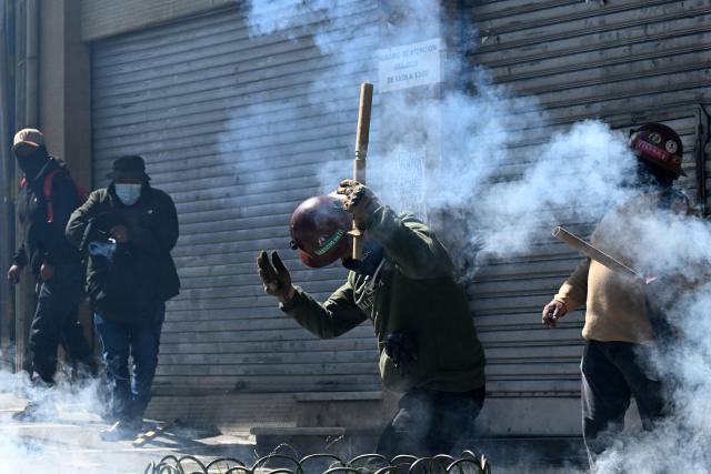 Miners clash with riot police during a protest demanding the resignation of Bolivian President Rodrigo Paz, in La Paz, on May 18, 2026. Bolivians have taken to the streets for the past two weeks, blocking roads into La Paz and disrupting deliveries of food, medicine and other goods to the seat of government, while demanding higher wages, economic relief and the resignation of centre-right President Rodrigo Paz amid a severe economic crisis. (Photo by AIZAR RALDES / AFP)
