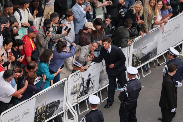 French-Canadian actor Niels Schneider greets fans as he leaves after the screening of the film "L'Inconnue" (The Unknown) at the 79th edition of the Cannes Film Festival in Cannes, southern France on May 18, 2026. (Photo by Thibaud MORITZ / AFP)