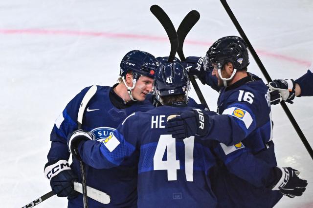 Finland's forward #15 Anton Lundell (L) celebrates with  teammates after scoring his team's sixth goal during the IIHF Ice Hockey Men's World Championship first round group A match between Finland and USA at the Swiss Life Arena in Zurich on May 18, 2026. (Photo by SEBASTIEN BOZON / AFP)