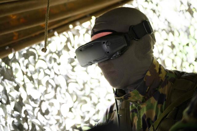A Swiss soldier controls an FPV drone during a demonstration of procedures for deploying mini-drones in combat situations by the Swiss Army's Drones and Robotics Defence Competence Centre at the Wichlen shooting range near Glarus-Sud on May 18, 2026. (Photo by HAROLD CUNNINGHAM / AFP)