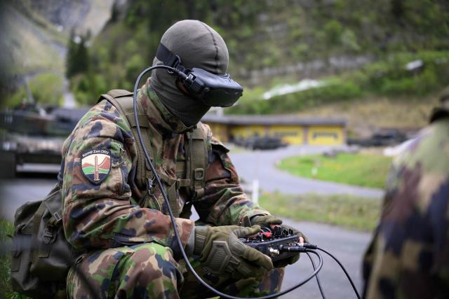 A Swiss soldier controls an FPV drone during a demonstration of procedures for deploying mini-drones in combat situations by the Swiss Army's Drones and Robotics Defence Competence Centre at the Wichlen shooting range near Glarus-Sud on May 18, 2026. (Photo by HAROLD CUNNINGHAM / AFP)