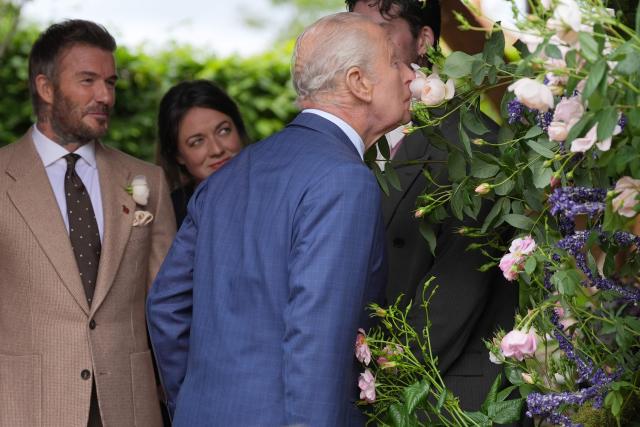 Former England footballer David Beckham (L) and designer Frances Tophill react as Britain's King Charles III smells a Sir David Beckham Rose, by David Austin Roses, at the 2026 RHS Chelsea Flower Show in London on May 18, 2026. (Photo by Yui Mok / POOL / AFP)
