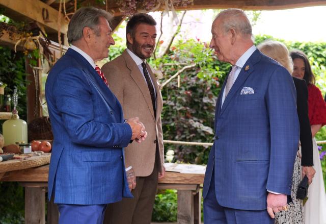Britain's King Charles III and Britain's Queen Camilla are greeted by former England footballer David Beckham, and Gardener and Broadcaster Alan Titchmarsh, as they view The RHS and The King's Foundation Curious Garden at the 2026 RHS Chelsea Flower Show in London on May 18, 2026. (Photo by Yui Mok / POOL / AFP)