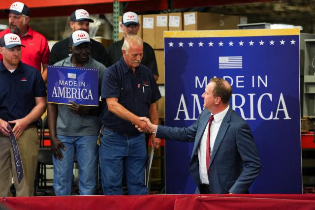 US Senator Eric Schmitt, a Republican of Missouri greets Milbank Workers during an event with US Vice President JD Vance at Milbank Manufacturing Company in Kansas City, Missouri, on May 18, 2026. (Photo by Eric Lee / POOL / AFP)