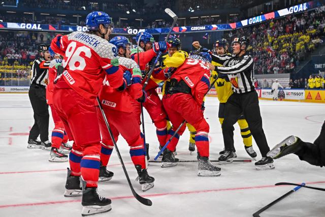 Players fight during the Group B ice hockey match between Sweden and Czech Republic at the IIHF Ice Hockey Men's World Championship at BFC Arena in Fribourg on May 18, 2026. (Photo by Fabrice COFFRINI / AFP)