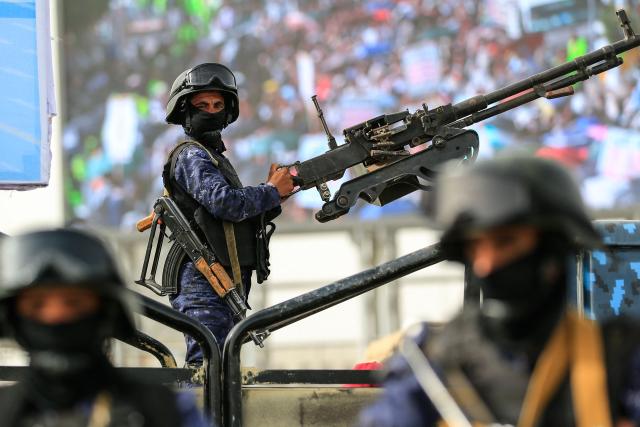 Security forces stand guard during a rally by supporters of the Iran-backed Houthi movement in solidarity with Lebanon, in Sanaa on May 18, 2026. Hezbollah drew Lebanon into the Middle East war on March 2 with rocket fire at Israel in retaliation for the killing of Iran's supreme leader in US-Israeli strikes days earlier. (Photo by Mohammed HUWAIS / AFP)