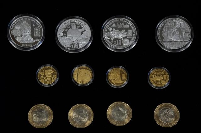 View of 12 commemorative coins for the 2026 FIFA World Cup at the headquarters of the Bank of Mexico, in Mexico City, on May 18, 2026. The new coins are dedicated to venues that will host the 2026 FIFA World Cup in Mexico, while others highlight the country's natural, historical and cultural heritage, with four additional coins set to enter general circulation (Photo by Alfredo ESTRELLA / AFP)