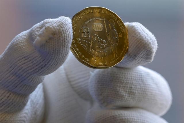 View of one of the 12 commemorative coins issued for the 2026 FIFA World Cup at the headquarters of the Bank of Mexico, in Mexico City, on May 18, 2026. The new coins are dedicated to venues that will host the 2026 FIFA World Cup in Mexico, while others highlight the country's natural, historical and cultural heritage, with four additional coins set to enter general circulation (Photo by Alfredo ESTRELLA / AFP)