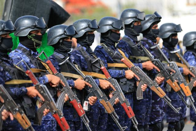Security forces stand guard during a rally by supporters of the Iran-backed Houthi movement in solidarity with Lebanon, in Sanaa on May 18, 2026. Hezbollah drew Lebanon into the Middle East war on March 2 with rocket fire at Israel in retaliation for the killing of Iran's supreme leader in US-Israeli strikes days earlier. (Photo by Mohammed HUWAIS / AFP)