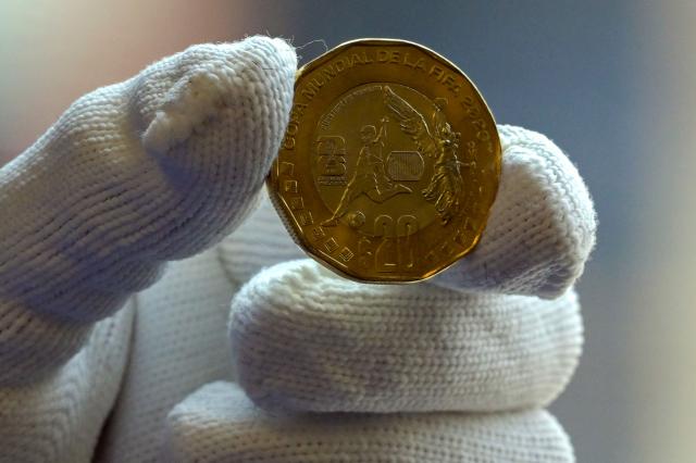 View of one of the 12 commemorative coins issued for the 2026 FIFA World Cup at the headquarters of the Bank of Mexico, in Mexico City, on May 18, 2026. The new coins are dedicated to venues that will host the 2026 FIFA World Cup in Mexico, while others highlight the country's natural, historical and cultural heritage, with four additional coins set to enter general circulation (Photo by Alfredo ESTRELLA / AFP)