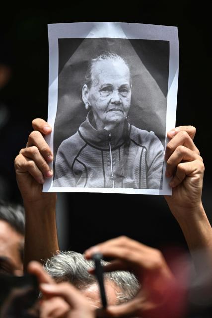 A student holds up the portrait of Carmen Navas, the mother of late political prisoner Victor Quero Navas, following her death, during a protest in Caracas, on May 18, 2026. The mother of Venezuelan political prisoner Victor Hugo Quero Navas died on May 17, 2026 at age 81, just days after confirming the death of her son in state custody, her relatives told AFP. (Photo by Juan BARRETO / AFP)