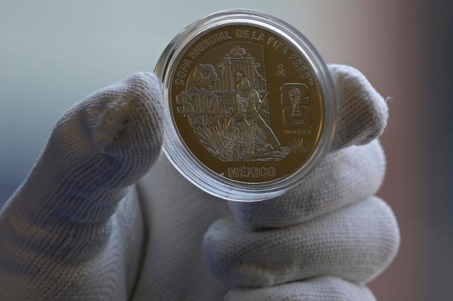 View of one of the 12 commemorative coins issued for the 2026 FIFA World Cup at the headquarters of the Bank of Mexico, in Mexico City, on May 18, 2026. The new coins are dedicated to venues that will host the 2026 FIFA World Cup in Mexico, while others highlight the country's natural, historical and cultural heritage, with four additional coins set to enter general circulation (Photo by Alfredo ESTRELLA / AFP)