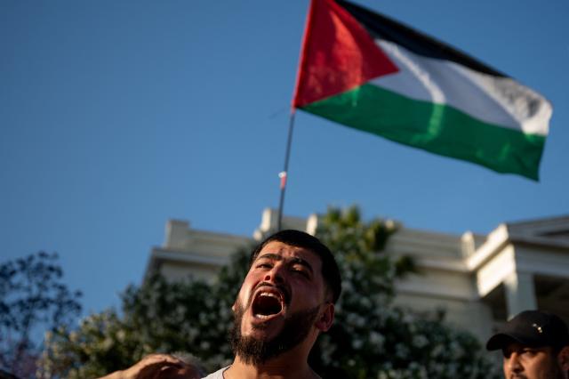 A protester chants during a gathering against the recent interception of the Global Solidarity Flotilla by the Israeli Navy near Cyprus outside the Ministry of Foreign Affairs in Athens on May 18, 2026. (Photo by Aggelos NAKKAS / AFP)