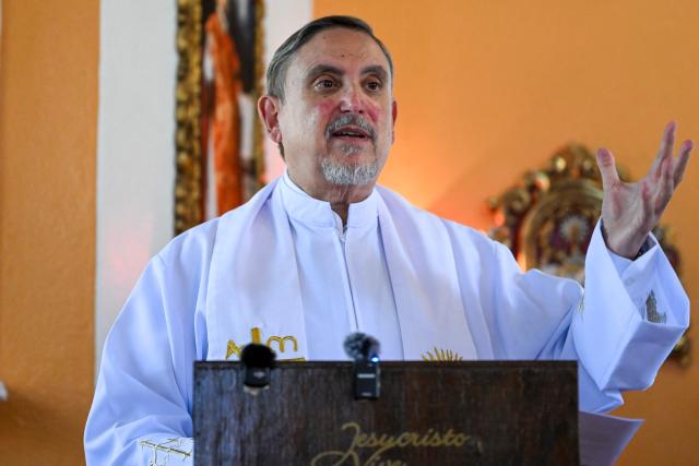 Priest Miquel Cortes conducts a religious ceremony in honour of Salvadoran lawyer Ruth Lopez at the chapel of Rafael Landнvar University in Guatemala City on May 18, 2026, who marked one year in detention in El Salvador. The NGO Cristosal demanded proof regarding the health of Salvadoran lawyer Ruth Lopez, who was arrested a year ago after reporting alleged corruption cases in Nayib Bukele’s government and who is being denied family visits. (Photo by JOHAN ORDONEZ / AFP)