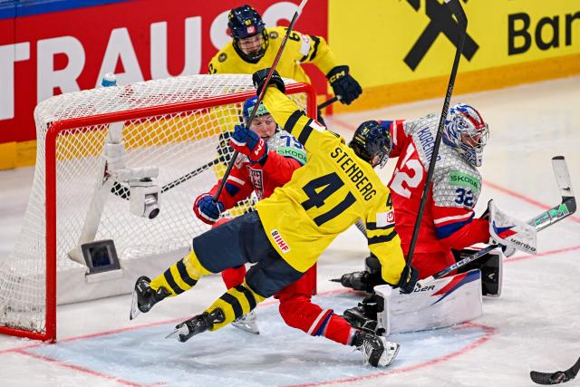 Sweden's forward #41 Ivar Stenberg (front) falls next to Czech Republic's defender #79 Tomas Galvas during the Group B ice hockey match between Sweden and Czech Republic at the IIHF Ice Hockey Men's World Championship at BFC Arena in Fribourg on May 18, 2026. (Photo by Fabrice COFFRINI / AFP)