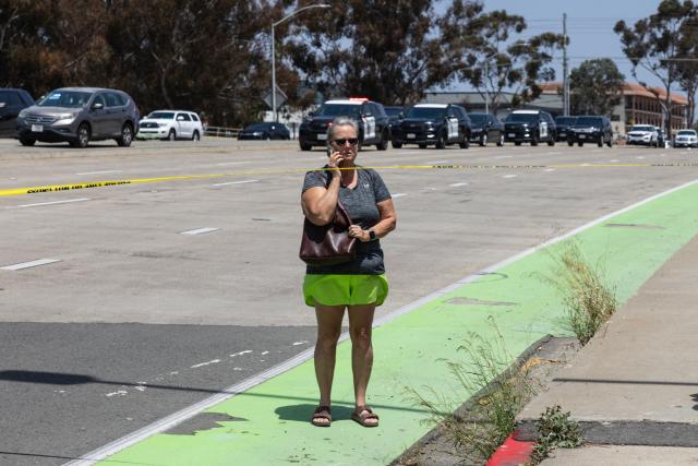 A woman speaks on her phone as police respond to a reported active shooter at the Islamic Center of San Diego in San Diego, California, on May 18, 2026. (Photo by Zoë Meyers / AFP)