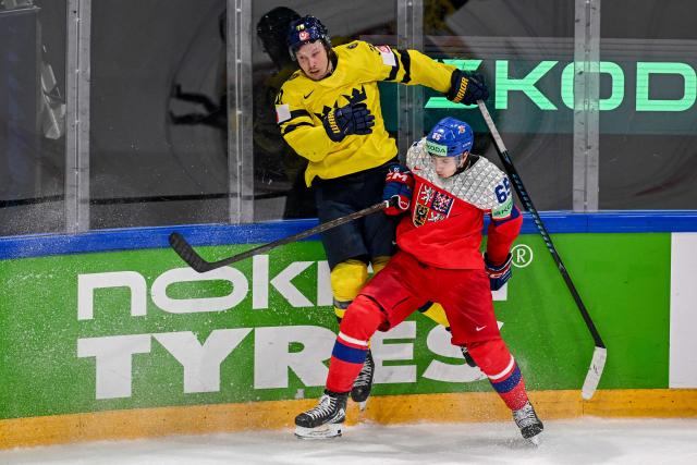 Sweden's forward #70 Oskar Sundqvist (L) is challenged by Czech Republic's defender #65 Tomas Cibulka during the Group B ice hockey match between Sweden and Czech Republic at the IIHF Ice Hockey Men's World Championship at BFC Arena in Fribourg on May 18, 2026. (Photo by Fabrice COFFRINI / AFP)