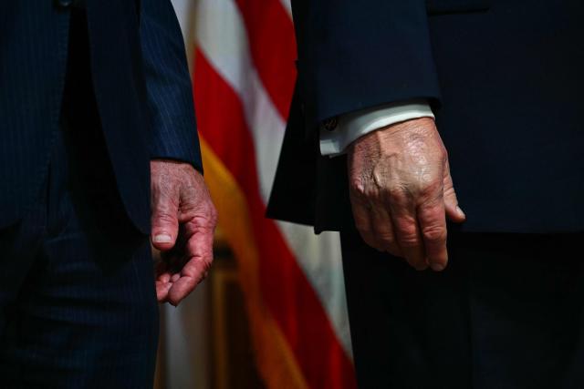 The hands of US Secretary of Health and Human Services Robert F. Kennedy Jr. (L) and US President Donald Trump are seen at a healthcare affordability event in the South Court Auditorium of The White House in Washington, DC, on May 18, 2026. (Photo by Kent NISHIMURA / AFP)