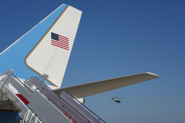 Marine Two, carrying US Vice President JD Vance, flies with Air Force Two standing in the foreground, following Vance's visit to Kansas City, at Joint Base Andrews, Maryland, on May 18, 2026. (Photo by Eric Lee / POOL / AFP)