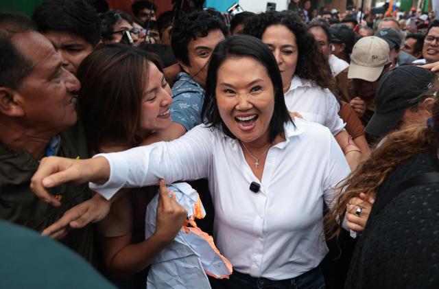 Peru's presidential candidate for the Fuerza Popular party, Keiko Fujimori, greets supporters during a campaign event at the Eden market in Callao, Peru on May 18, 2026. Right-wing candidate Keiko Fujimori and left-wing candidate Roberto Sanchez will face off on June 7 in Peru's presidential runoff, the electoral authority confirmed on May 17 when it officially proclaimed the results. (Photo by Connie FRANCE / AFP)