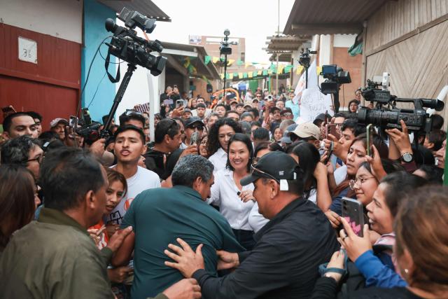 Peru's presidential candidate for the Fuerza Popular party, Keiko Fujimori (C), greets supporters during a campaign event at the Eden market in Callao, Peru on May 18, 2026. Right-wing candidate Keiko Fujimori and left-wing candidate Roberto Sanchez will face off on June 7 in Peru's presidential runoff, the electoral authority confirmed on May 17 when it officially proclaimed the results. (Photo by Connie FRANCE / AFP)