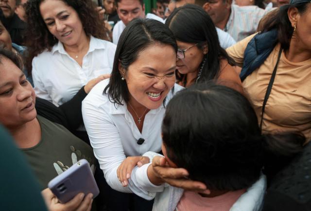 Peru's presidential candidate for the Fuerza Popular party, Keiko Fujimori, greets supporters during a campaign event at the Eden market in Callao, Peru on May 18, 2026. Right-wing candidate Keiko Fujimori and left-wing candidate Roberto Sanchez will face off on June 7 in Peru's presidential runoff, the electoral authority confirmed on May 17 when it officially proclaimed the results. (Photo by Connie FRANCE / AFP)