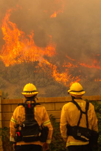 Fire fighters monitor the Sandy Fire as it burns in the hills close to a residential area in Simi Valley, California, on May 18, 2026. About 24,000 people in Simi Valley, 40 miles northwest of Los Angeles, are under mandatory evacuation orders as the Sandy Fire is "spreading dangerously fast" according to fire officials. (Photo by Apu GOMES / AFP)